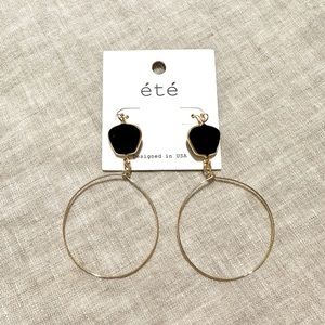 Gold statement earrings with black stones